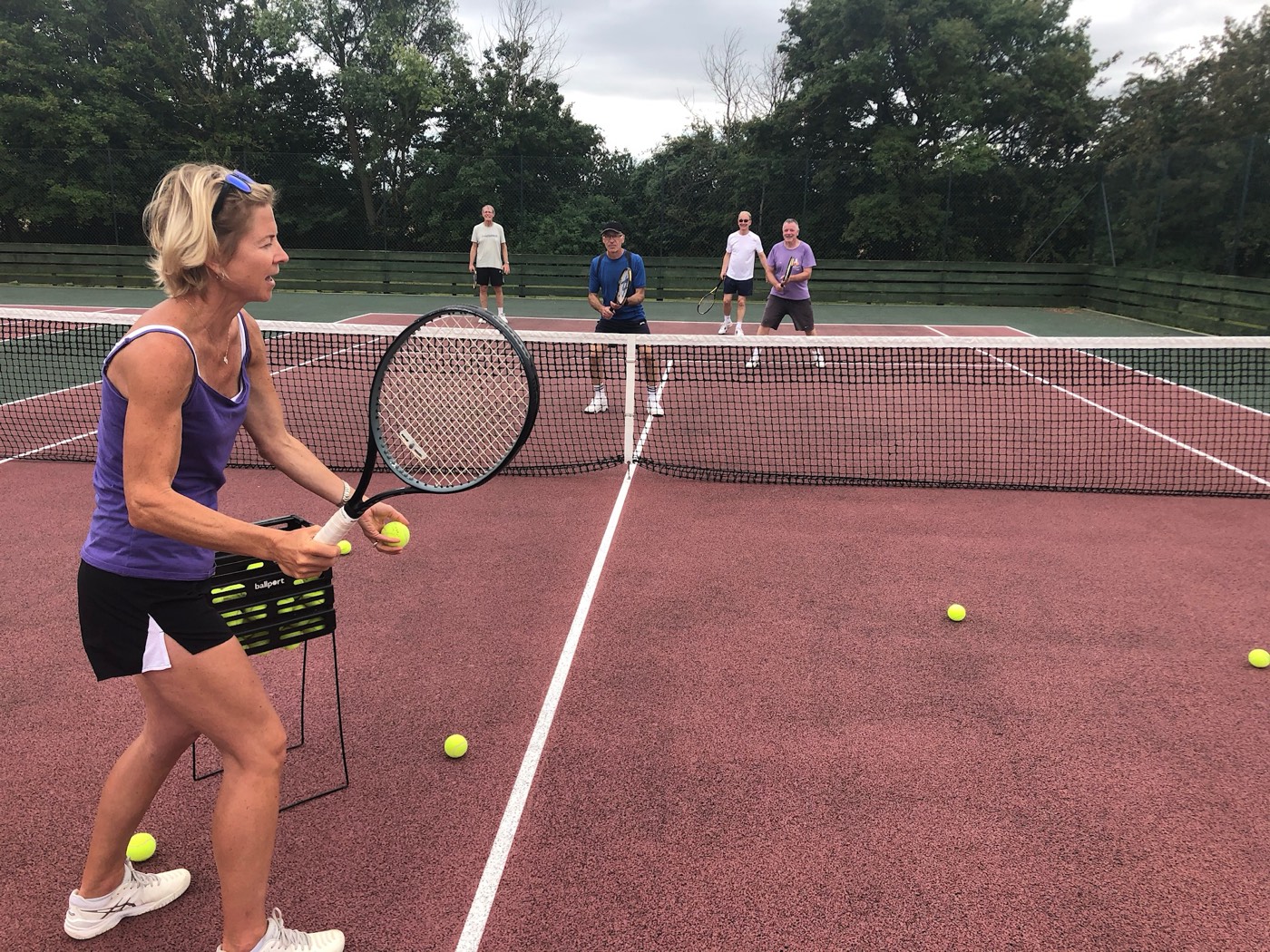 Olga Blecher coaching a group tennis lesson at Pirton Tennis Club